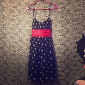 Black with white polkadots dress with red ribbon.